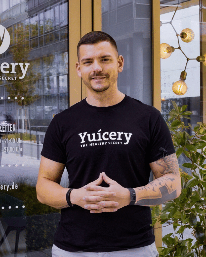 Man standing in front of juice shop.