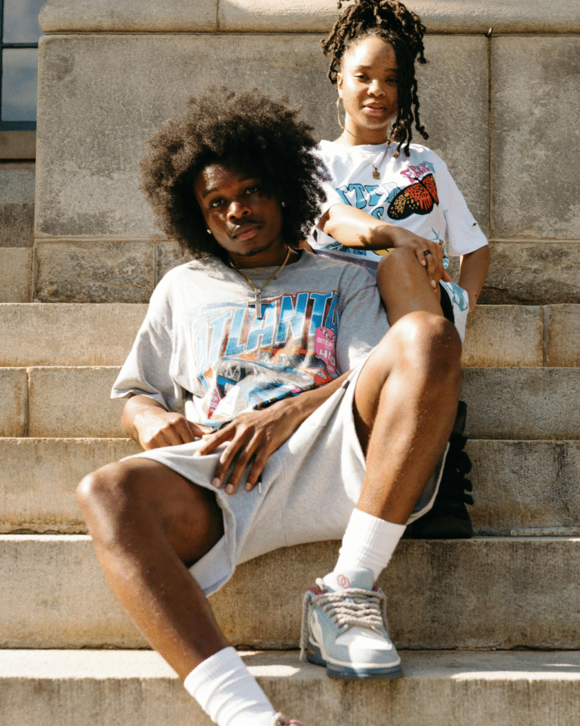 Two people sitting on stone steps.